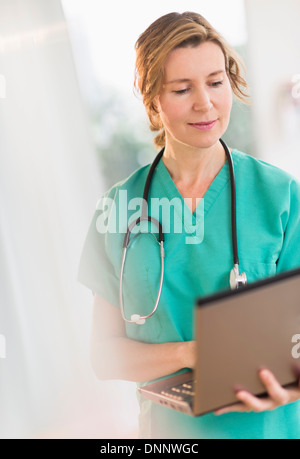 Female doctor using laptop Stock Photo