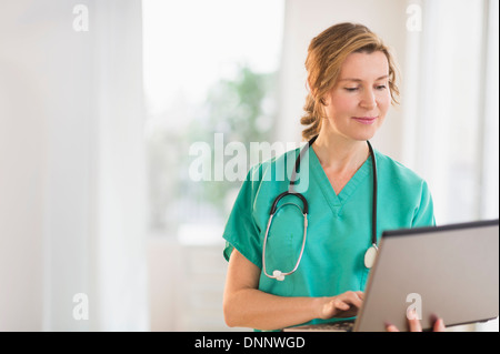 Female doctor using laptop Stock Photo