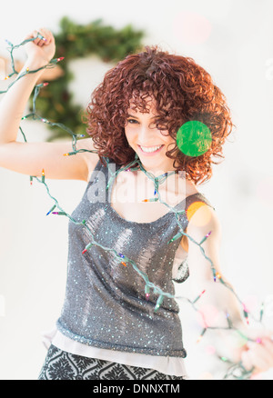 Woman holding christmas lights Stock Photo