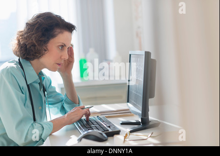Female doctor working on computer Stock Photo