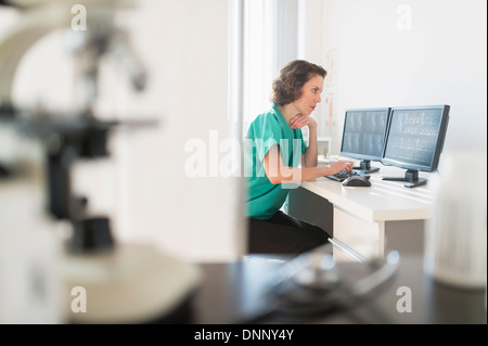 Female technician working on computer Stock Photo