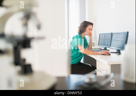 Female technician working on computer Stock Photo