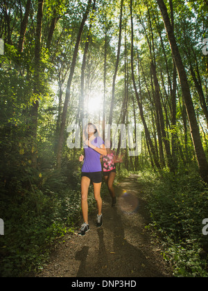 USA, Oregon, Portland, Two young women jogging in forest Stock Photo