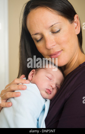 Portrait of mother holding newborn baby (0-11 months) Stock Photo