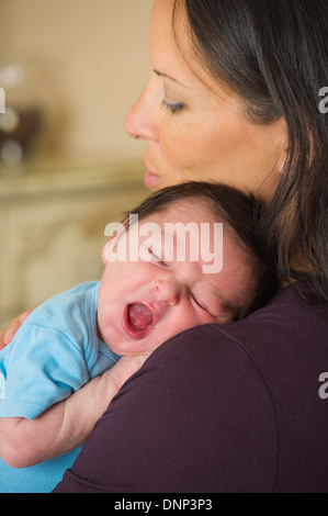 Portrait of mother holding newborn baby (0-11 months) Stock Photo