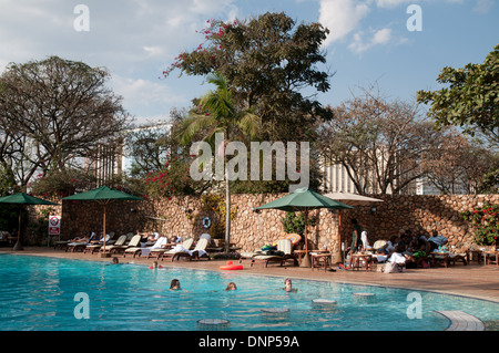 Swimmers enjoying a swim in the Nairobi Serena Hotel swimming pool Nairobi Kenya Stock Photo