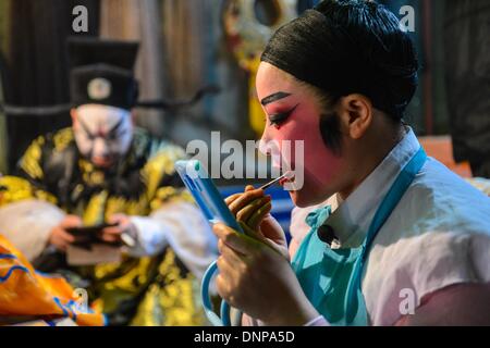 Wuyi, China's Zhejiang Province. 3rd Jan, 2014. An actor of a local traditional opera troupe makes up himself before performing at Wuyi County in Jinhua City, east China's Zhejiang Province, Jan. 3, 2014. The Wu Opera, also called Jinhua Opera, is a local traditional opera with a histoy of more than 400 years. Wu Opera troups here would perform for local residents to celebrate festivals like the New Year. © Xu Yu/Xinhua/Alamy Live News Stock Photo
