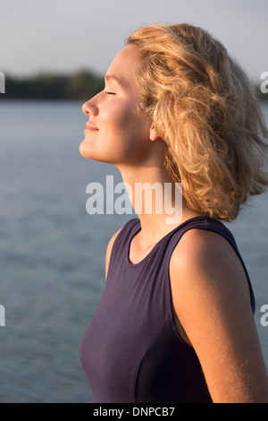 Netherlands, Gelderland, De Rijkerswoerdse Plassen, Beautiful woman with closed eyes standing in lake Stock Photo