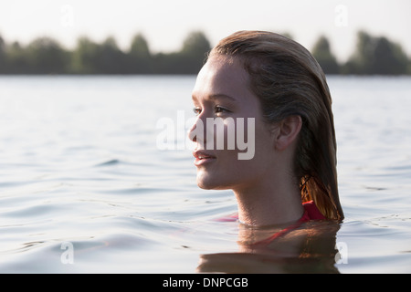 Netherlands, Gelderland, De Rijkerswoerdse Plassen, Woman relaxing in lake, Profile Stock Photo