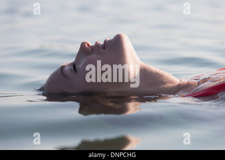 Woman relaxing in lake Stock Photo
