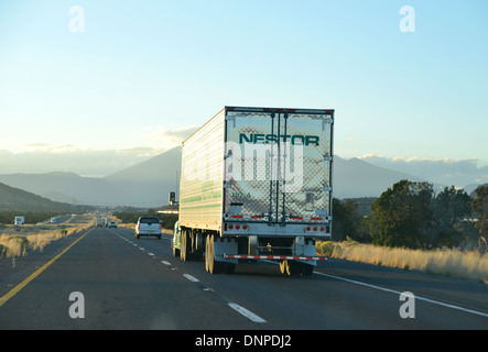 Big rig American truck and trailer drive West into the sunset on Route 66, Arizona Stock Photo