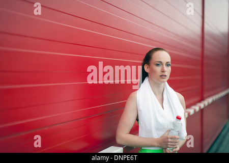 Portrait of woman holding bottle of water Stock Photo