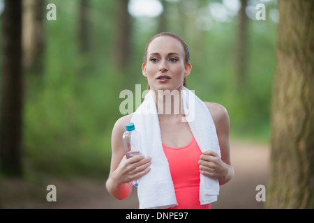 Netherlands, Erp, Portrait of woman holding bottle of water Stock Photo