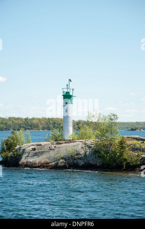 Small lighthouse or light beacon on tiny island in the Thousand Islands on the St. Lawrence River, Ontario, and New York Stock Photo