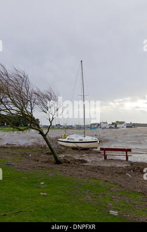 Christchurch, UK. 03rd Jan, 2014. Yacht breaks mooring, drifts ashore. Local harbourside houses battered by storm winds and waves with some flooding Credit:  Roger Allen Photography/Alamy Live News Stock Photo