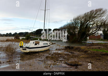 Christchurch, UK. 03rd Jan, 2014. Yacht breaks mooring, drifts ashore. Local harbourside houses battered by storm winds and waves with some flooding Credit:  Roger Allen Photography/Alamy Live News Stock Photo