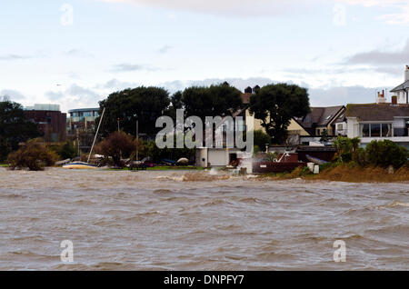 Christchurch, UK. 03rd Jan, 2014. Yacht breaks mooring, drifts ashore. Local harbourside houses battered by storm winds and waves with some flooding Credit:  Roger Allen Photography/Alamy Live News Stock Photo