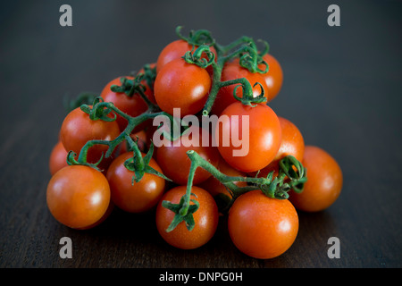 Cherry tomatoes on a dark wooden board