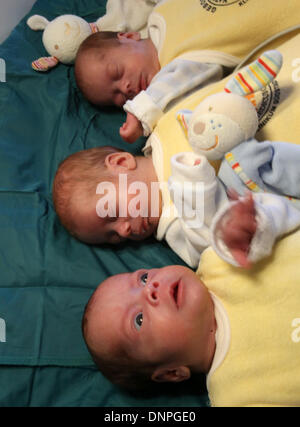 Rostock, Germany. 03rd Jan, 2014. The triplets Ben, Max and Till (bottom-top) lie in a bed in the South City Hospital in Rostock, Germany, 03 January 2014. Two and a half months after their birth on 22 October 2013, the triplets are now discharged home. The boys were born with a weight of 1200 to 1320 grams after only 29 weeks of gestation. Photo: Bernd Wuestneck/dpa/Alamy Live News Stock Photo