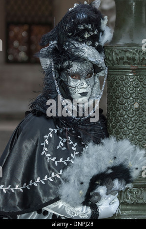 Carnival participant wearing elaborate black costume and silver mask Stock Photo