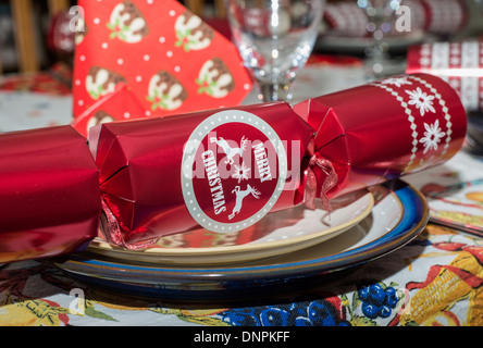 Christmas dinner table setting including a cracker on a plate Stock Photo