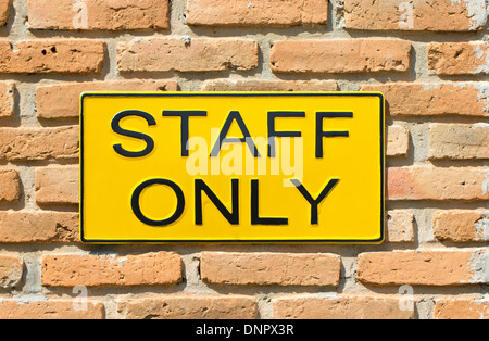 staff only sign on brick wall. Stock Photo