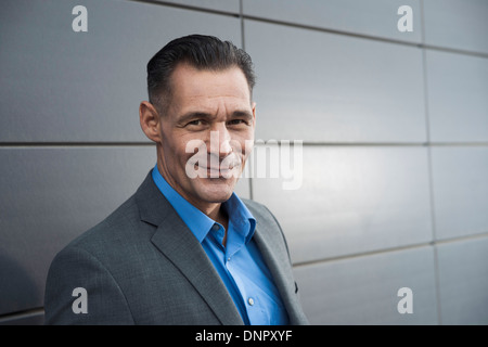 Portrait of businessman standing in front of building, Mannheim, Germany Stock Photo