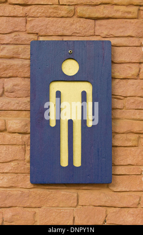 Male toilet sign on the brick wall. Stock Photo