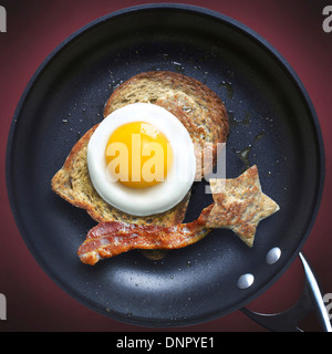 view of frying pan with bacon, egg and toast Stock Photo