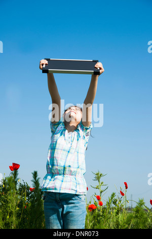 Girl Holding Solar Panel up in the Air, Mannheim, Baden-Wurttemberg, Germany Stock Photo