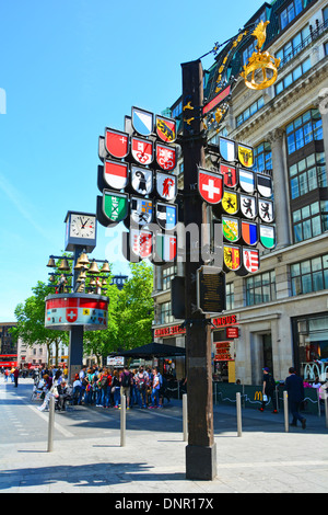 Cantonal tree display of the twenty six Cantons of Switzerland in Leicester Square with bells from the old Swiss Centre beyond Stock Photo