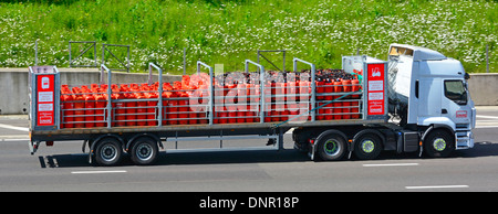 Calor Gas hgv lorry truck and articulated trailer fully loaded with Propane Gas Bottles driving along M25 motorway road Essex England UK Stock Photo