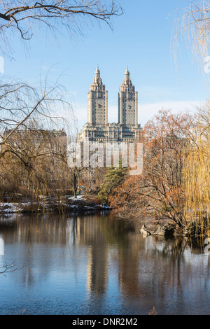San Remo Building overlooking Central Park and The Lake, Upper West Side, Manhattan, New York, with blue sky and reflections Stock Photo