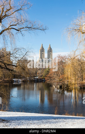 San Remo Building overlooking Central Park and The Lake, Upper West Side, Manhattan, New York, with blue sky and snow Stock Photo