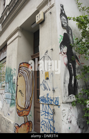 Oblique portrait graffiti scrawl and SOBR artist black suit party girl image paste-up, white walls Gipsstrasse 27, Berlin Stock Photo