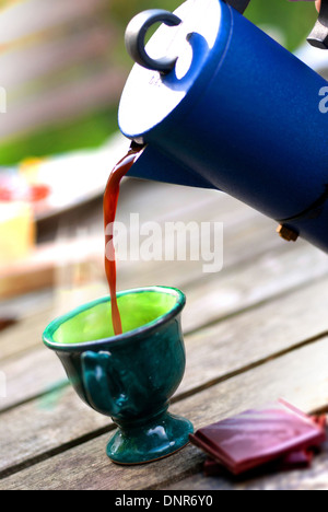 Pouring espresso coffee from classic blue coffee pot / Morning coffee Stock Photo