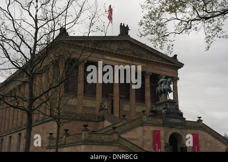 Grey sky view brown masonry Alte National Galerie, with equestrian statue Fredrick William IV of Prussia, Museum Island, Berlin Stock Photo