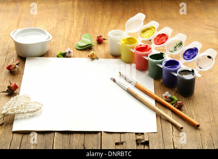painting set - brushes, paints (gouache) on old wooden table Stock Photo