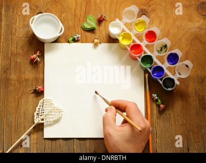 painting set - brushes, paints (gouache) on old wooden table Stock Photo