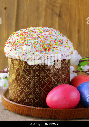 traditional Easter cake with glace icing and colorful eggs Stock Photo