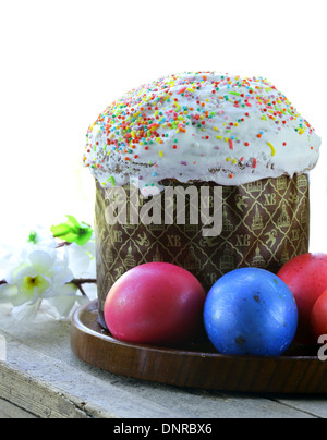 traditional Easter cake with glace icing and colorful eggs Stock Photo