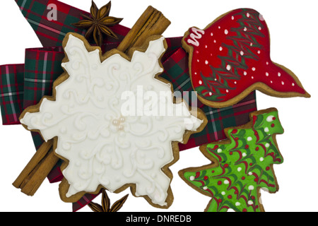 Iced cookies and spices with tartan ribbon isolated on white. Stock Photo