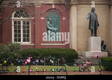 row of kids scooters parked in front of Plymouth Church in Brooklyn NYC Stock Photo