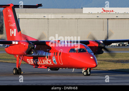 Transport Canada Dash 8 marine aerial surveillance airplane C-GSUR taxies on airport tarmac after patrol of Canada's coastline Stock Photo