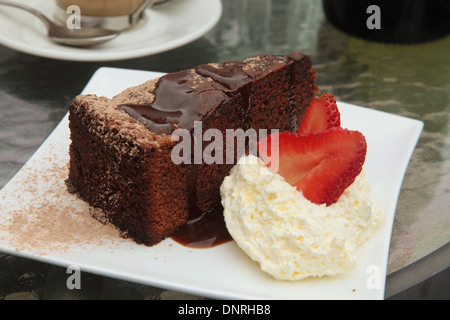 Chocolate Cake with Whipped Cream and Fruit Stock Photo