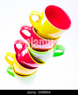 Yellow, Red, Green Color Cups. Leaning Tower Stack Of Clean Different Cups Isolated On White Background Stock Photo