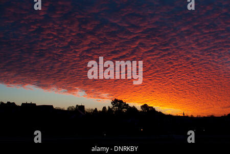 Warwick, Warwickshire, UK. 5th Jan, 2014. A dramatic dawn sky over Warwick town centre. The clear sky came after days of stormy weather across the UK. Credit:  Colin Underhill/Alamy Live News Stock Photo