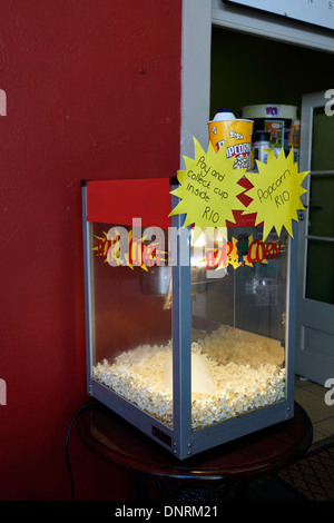 Red wall and popcorn machine outside shop in Franschhoek, Western Cape. Stock Photo
