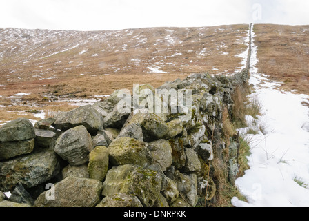 Drystone wall in the Mourne Mountains with snow in the winter. Stock Photo