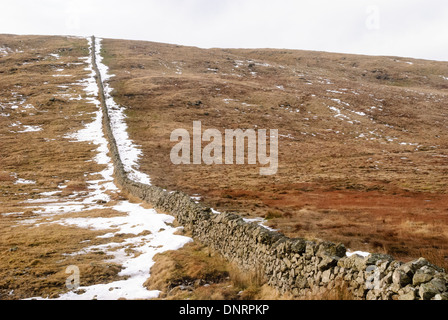 Drystone wall in the Mourne Mountains with snow in the winter. Stock Photo